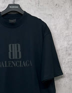 Black Balenciaga logo graphic T-shirt on hanger, short sleeves, crew neck