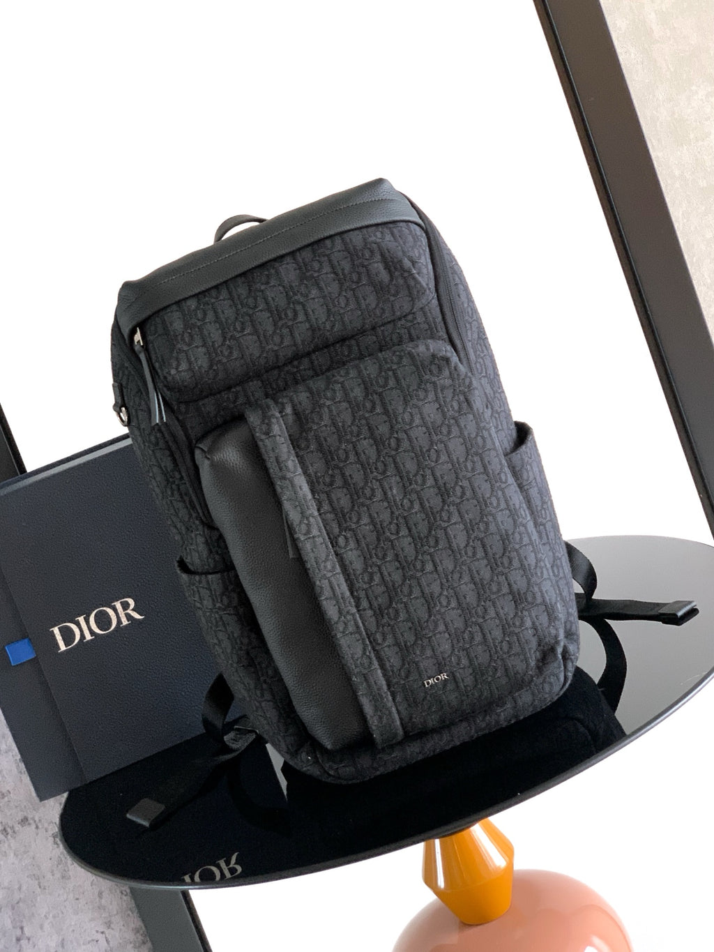 Men's Dior monogram backpack with padded top handle and adjustable shoulder straps
