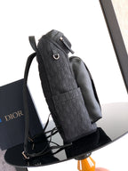 Dior monogram backpack, side view with top carry strap and black shoulder straps