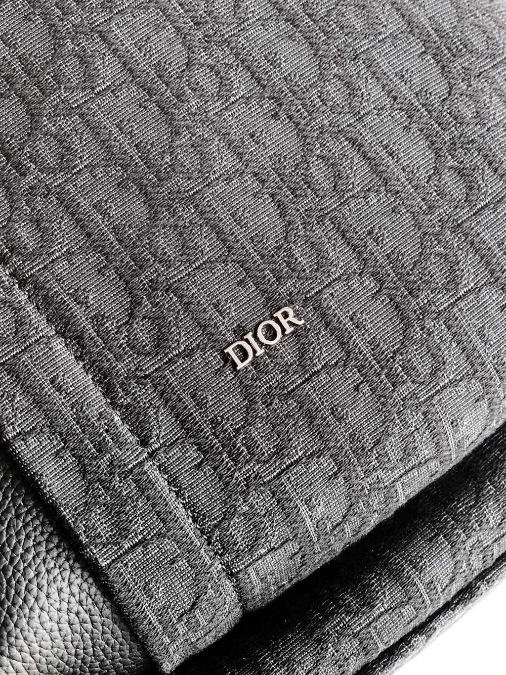 Dior logo patch on dark monogram fabric backpack panel