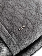 Dior logo patch on dark monogram fabric backpack panel