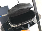 Dior monogram bag with black interior lining, open top view on display stand