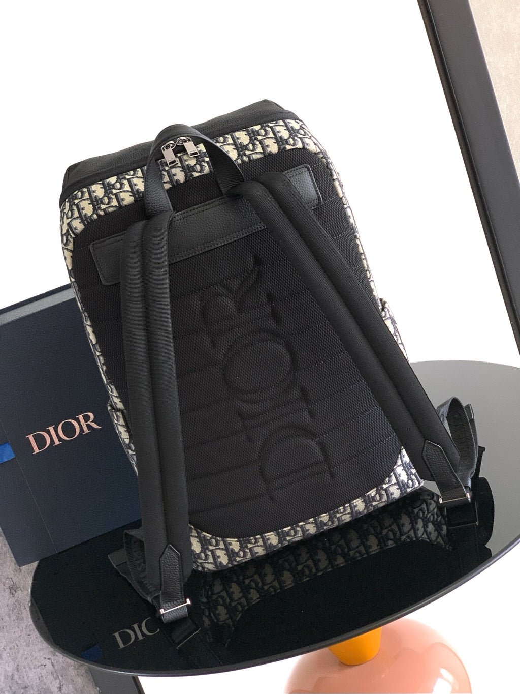 Dior men’s monogram backpack with black back panel and top carry handle