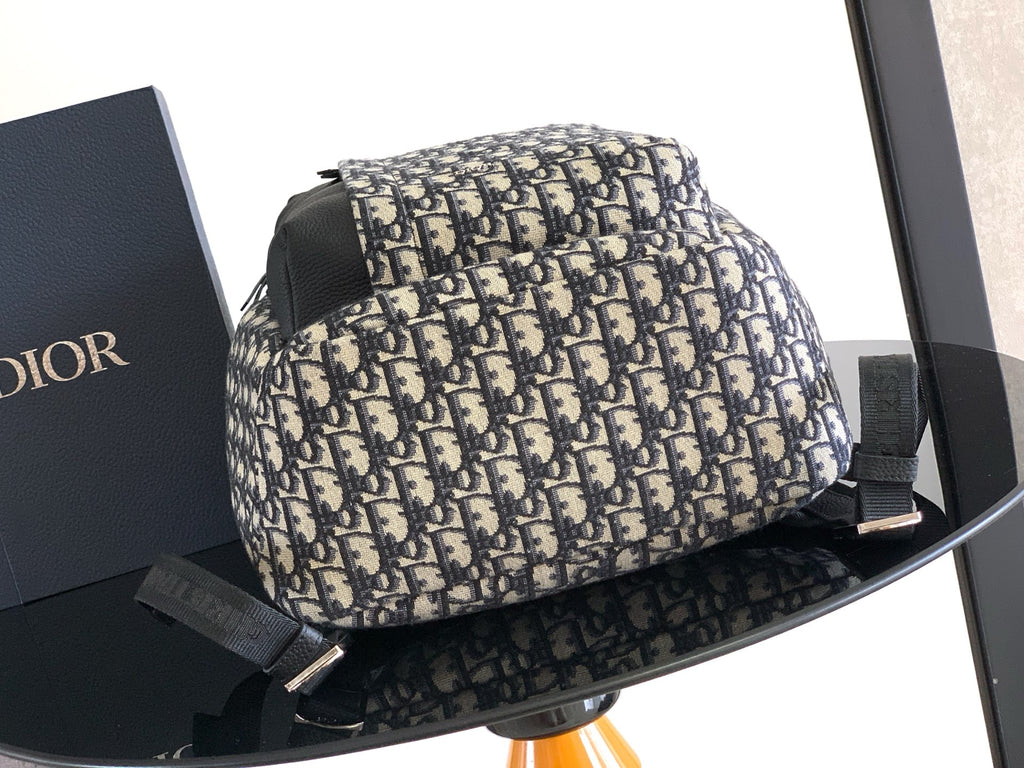Dior men’s monogram backpack with curved shape and front zip closure