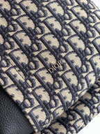 Dior monogram fabric panel on a backpack with stitched trim and Dior logo
