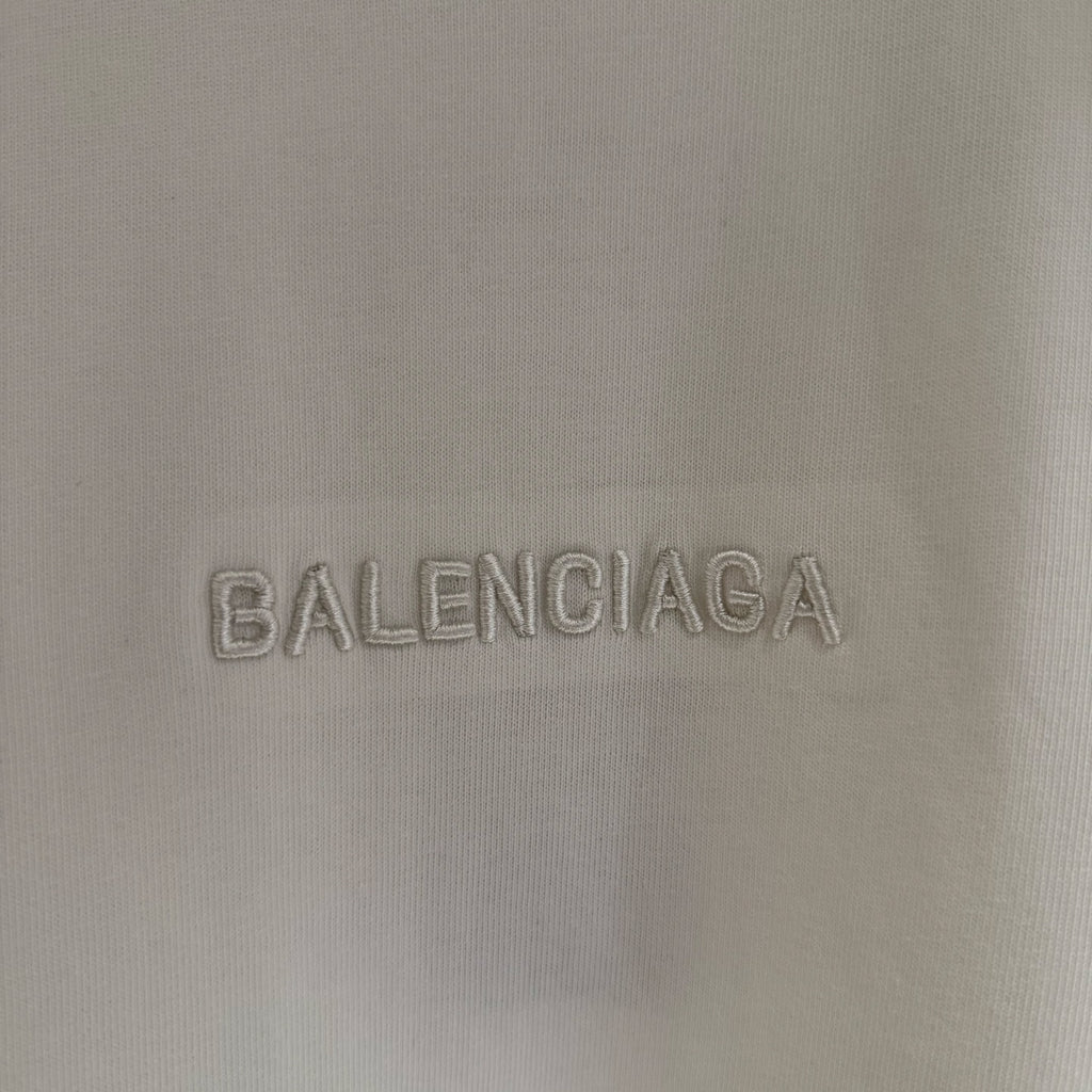 White Balenciaga T-shirt fabric close-up of BALENCIAGA logo embroidery