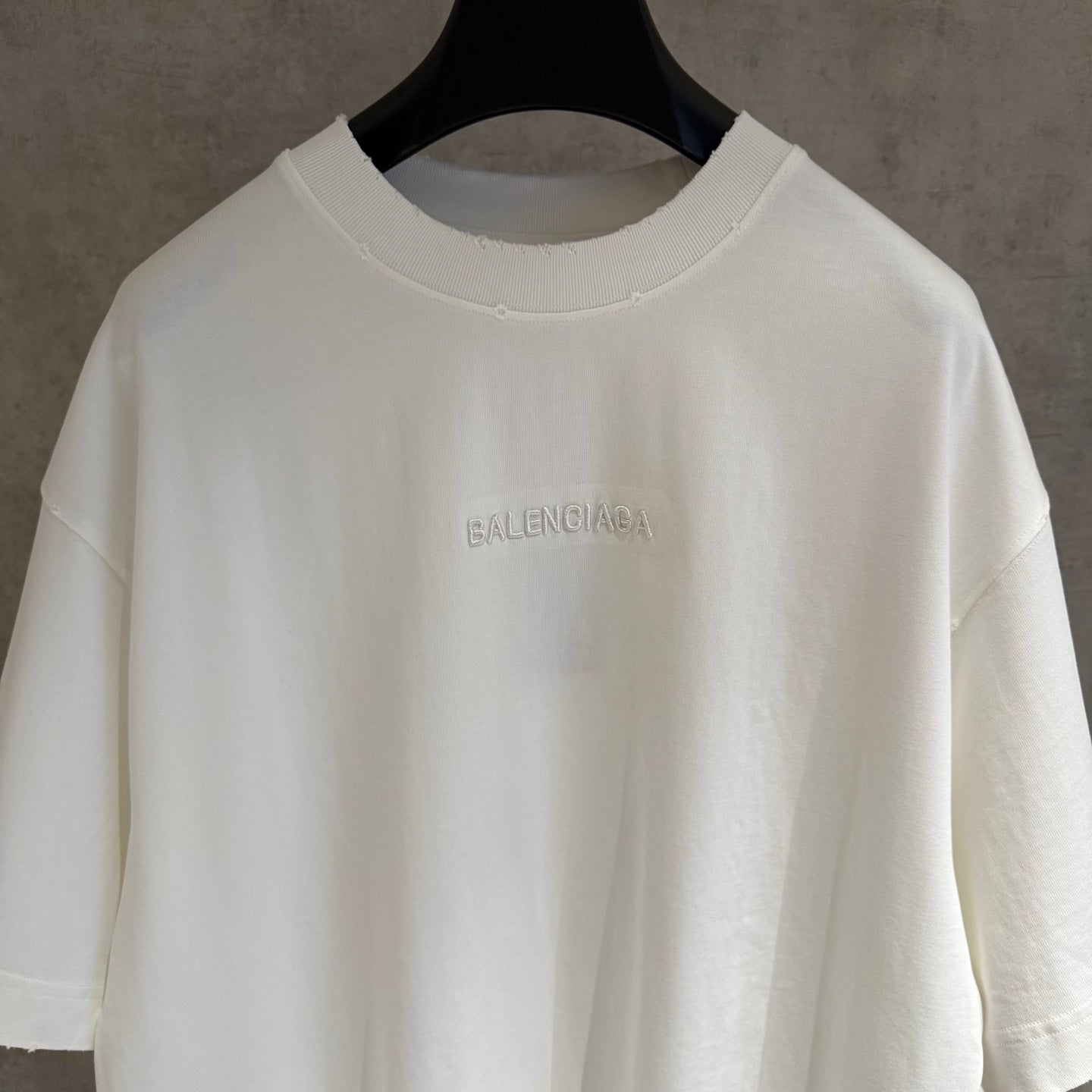 White Balenciaga T-shirt close-up of small chest BALENCIAGA logo on crew neck