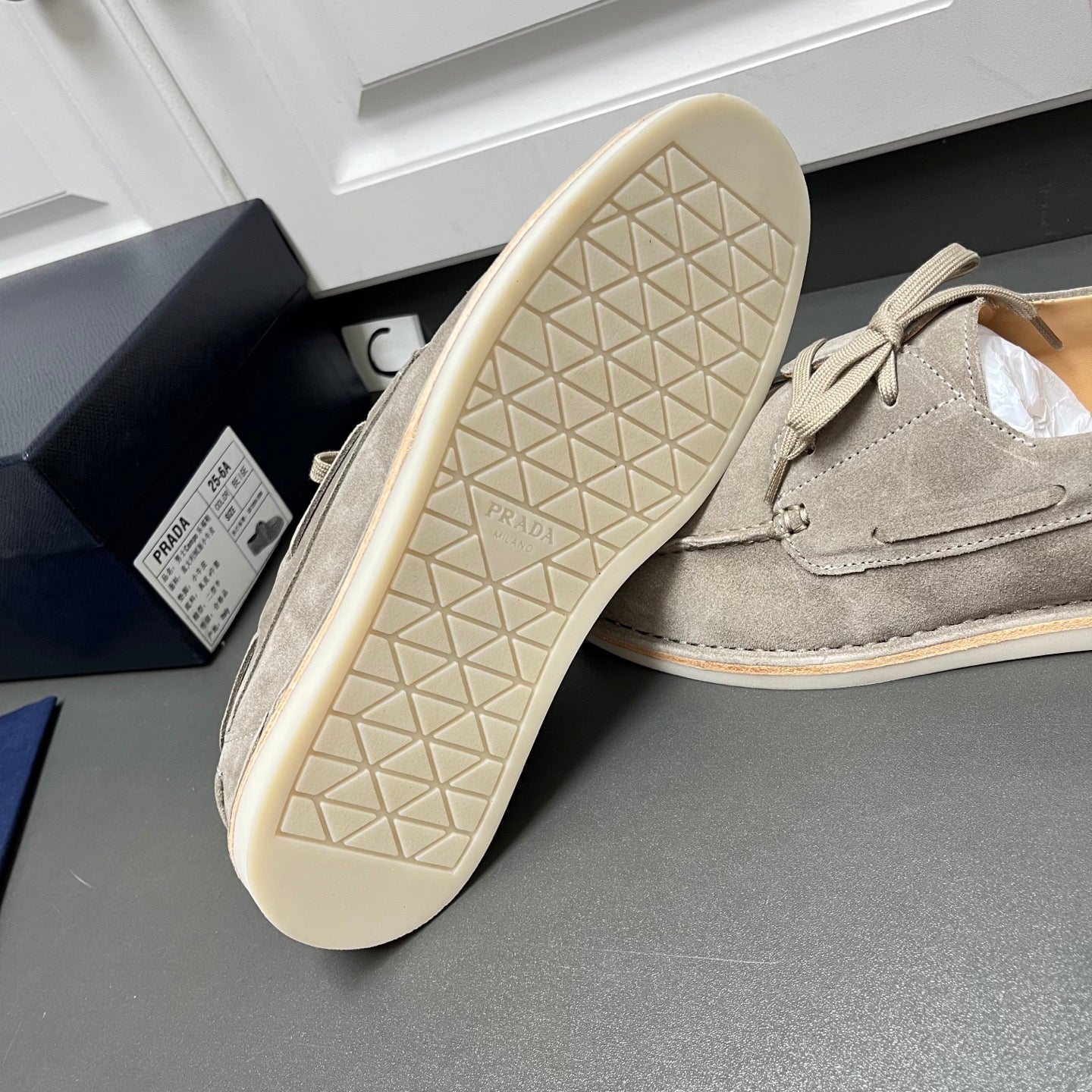 Prada unisex suede lace-up shoes in light gray, outsole tread view