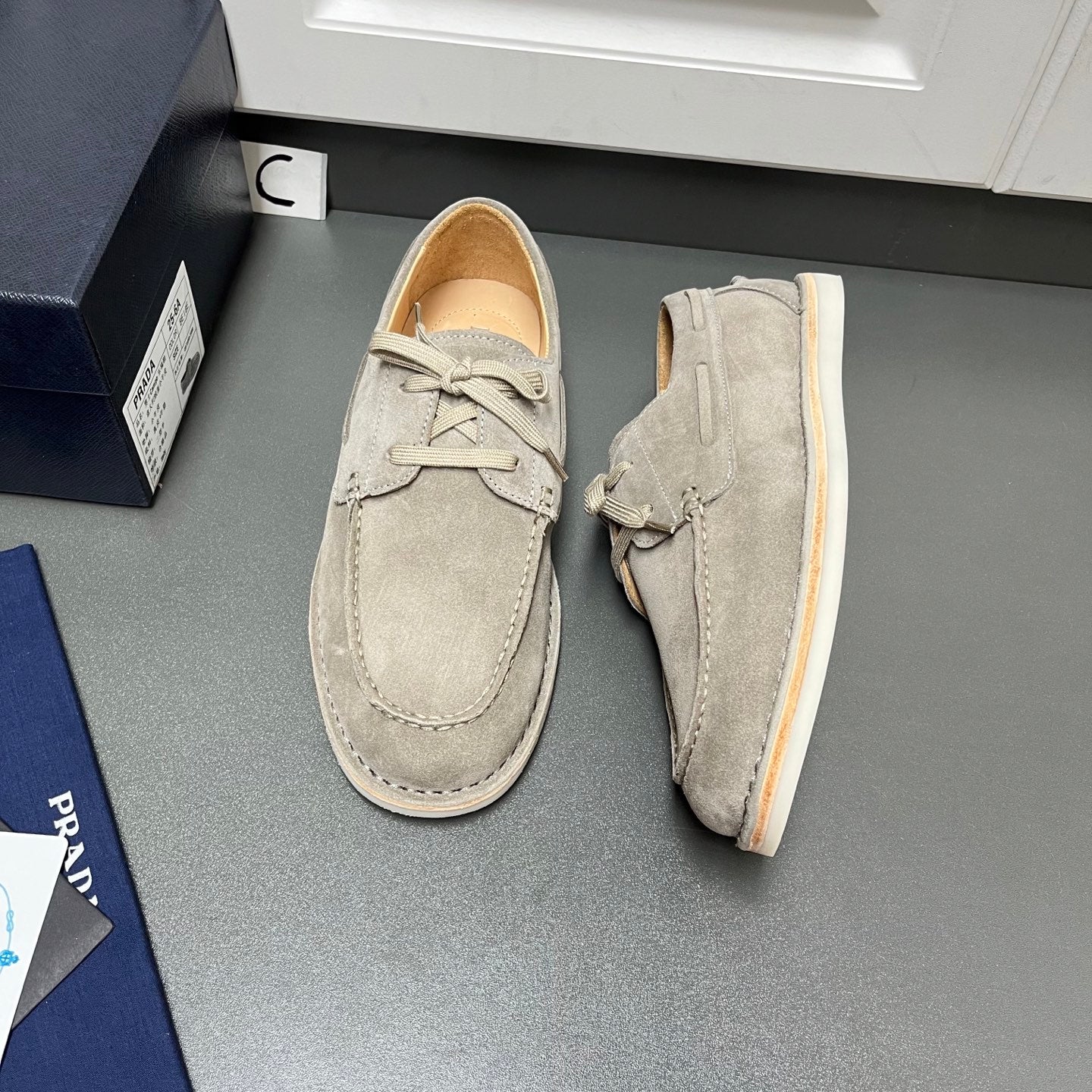 Prada unisex suede lace-up shoes in light gray, front view, cream sole