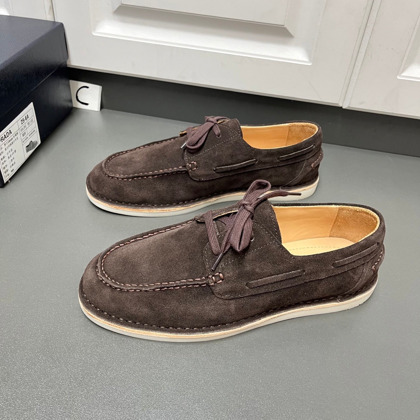 Prada unisex suede lace-up shoes in dark brown, moc-toe stitching, light sole