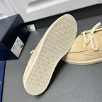 Beige suede loafers with textured rubber outsole and lace-up closure