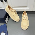 Beige suede lace-up loafers with moc-style stitching and flat white rubber sole