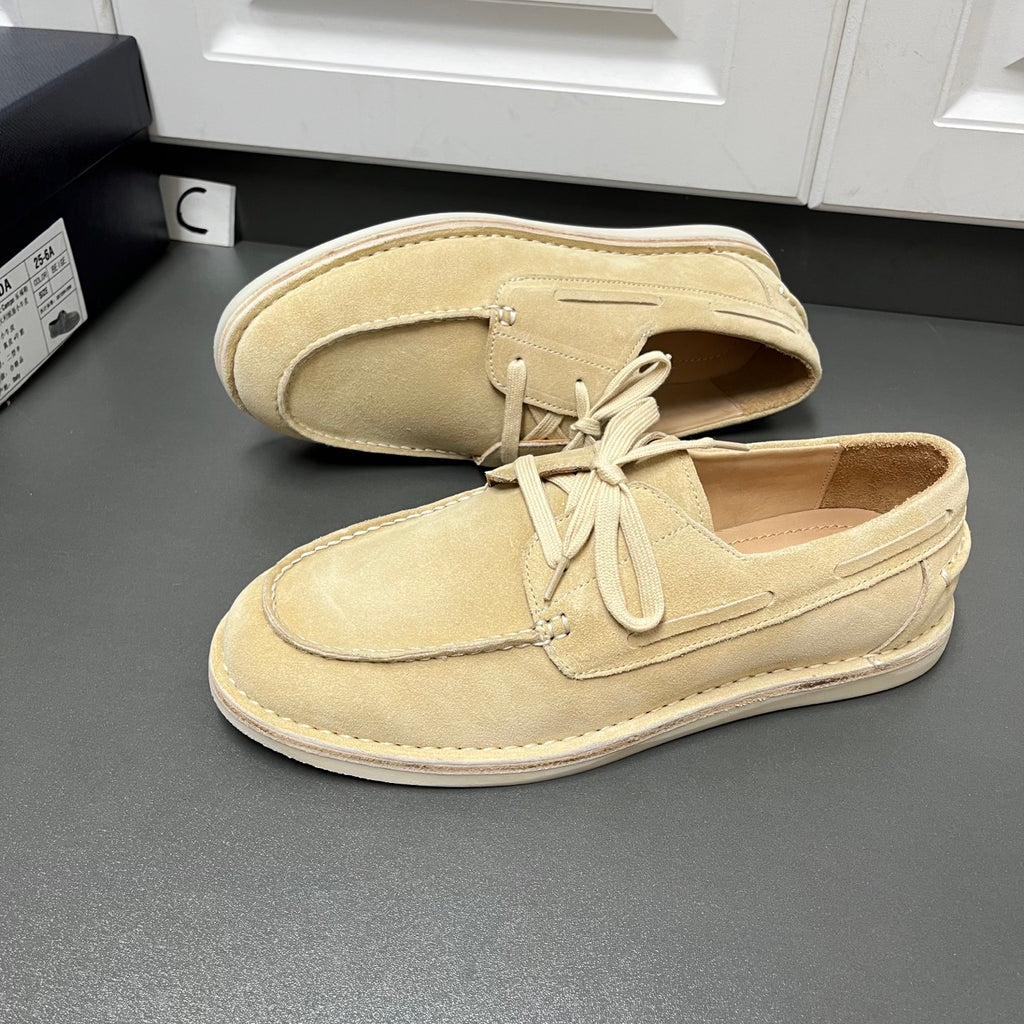 Beige suede lace-up loafers, side view, with white rubber sole and lace-up vamp