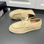 Beige suede lace-up loafers, side view, with white rubber sole and lace-up vamp