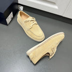 Beige suede lace-up loafers with folded heel detail and flat white rubber sole