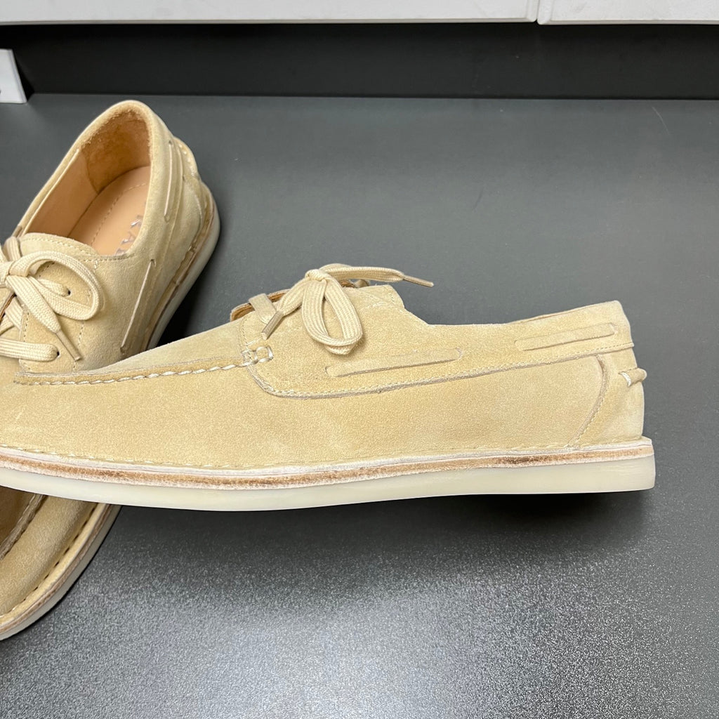 Beige suede lace-up loafer with textured seam detailing and flat white sole