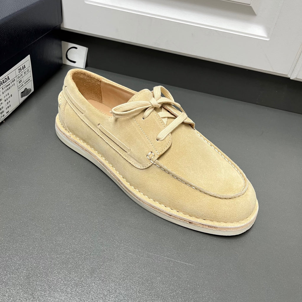 Beige suede lace-up loafers with minimal vamp seam and flat white rubber sole