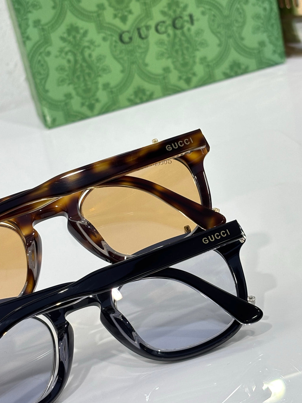 Round sunglasses close-up with tortoiseshell and black frames, tinted lens