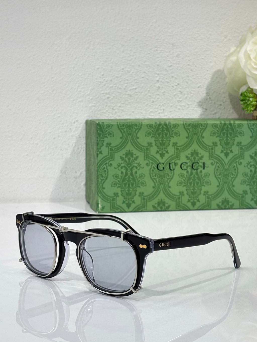 Round sunglasses with black frames and light-tinted lenses