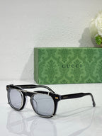 Round sunglasses with black frames and light-tinted lenses