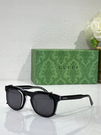 Round sunglasses with black frames and dark gray lenses