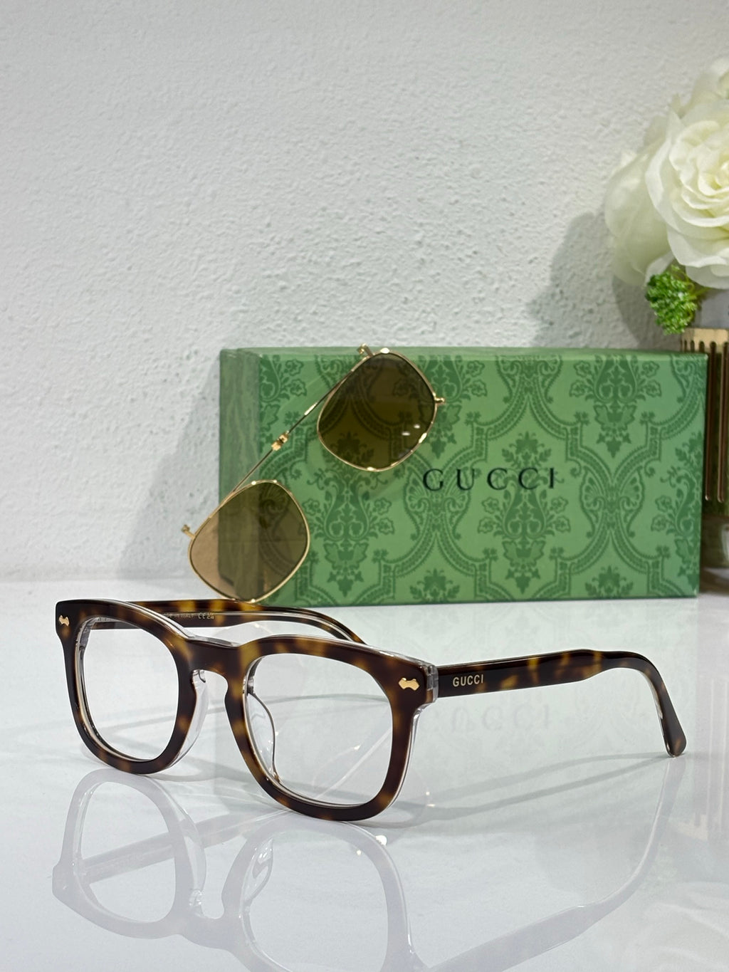 Tortoiseshell rectangular eyeglasses with clear lenses and Gucci logo on temple arms
