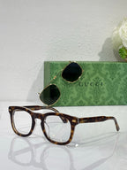 Tortoiseshell rectangular eyeglasses with clear lenses and Gucci logo on temple arms