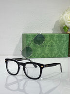 Black rectangular eyeglasses with clear lenses and Gucci logo on temple arms