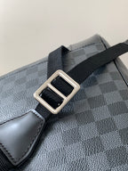 Men's Louis Vuitton checkered bag strap close-up with silver-tone buckle hardware