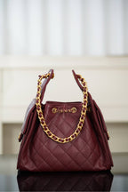 Chanel quilted shoulder bag in dark red with gold chain strap and top handle hardware