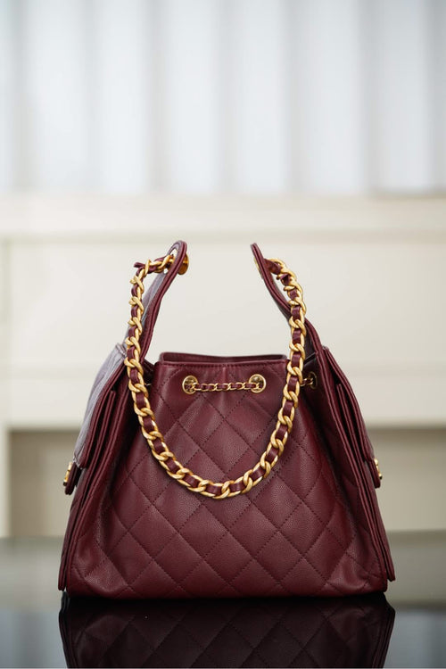 Chanel quilted shoulder bag in dark red with gold chain strap and top handle hardware