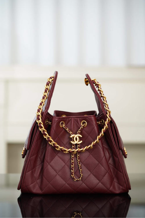 Chanel quilted shoulder bag in dark red with gold chain handles and CC logo charm