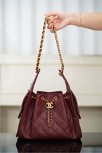 Chanel quilted shoulder bag in dark red with gold chain strap and front CC logo charm