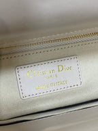 Christian Dior label reading MADE IN ITALY on white Dior handbag
