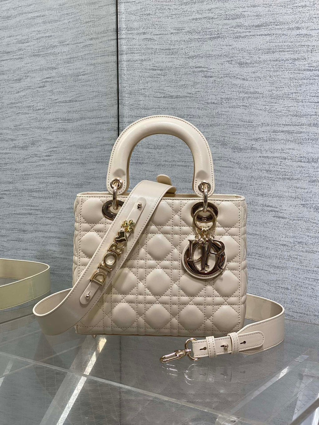 Cream quilted Dior handbag with top handles and silver-tone hardware