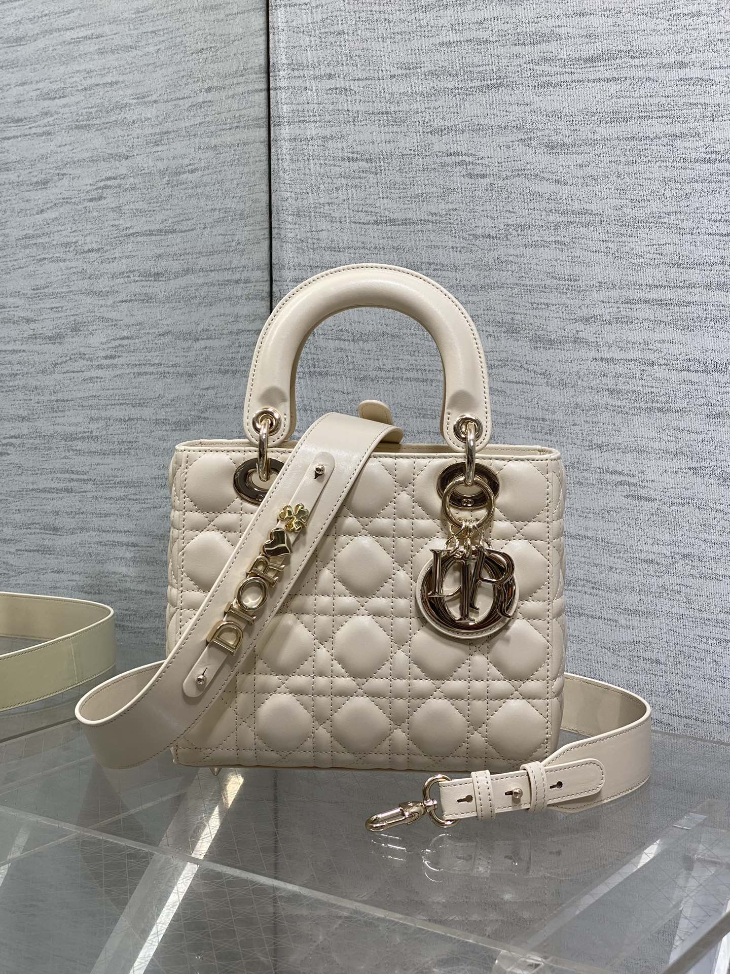 Cream quilted Dior handbag with top handles and silver-tone hardware