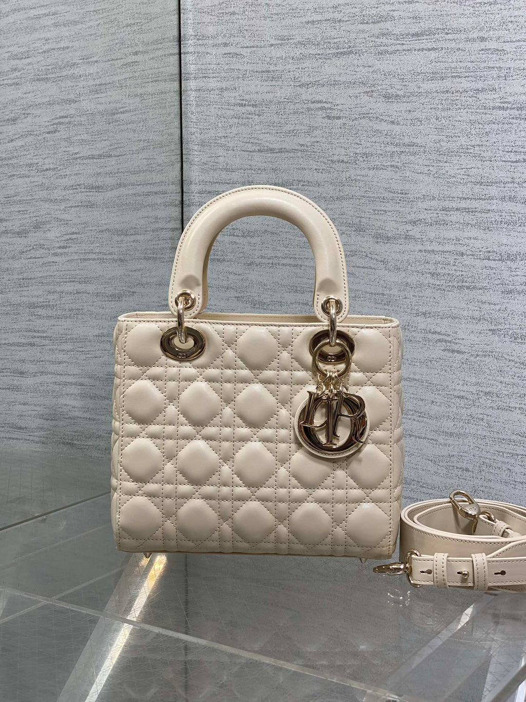 Cream quilted Dior mini bag with top handles and detachable shoulder strap