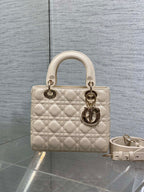 Cream quilted Dior mini bag with top handles and detachable shoulder strap