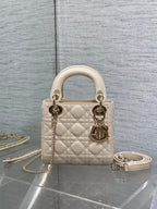 Light beige quilted Dior handbag, gold-tone hardware, top handles and chain strap