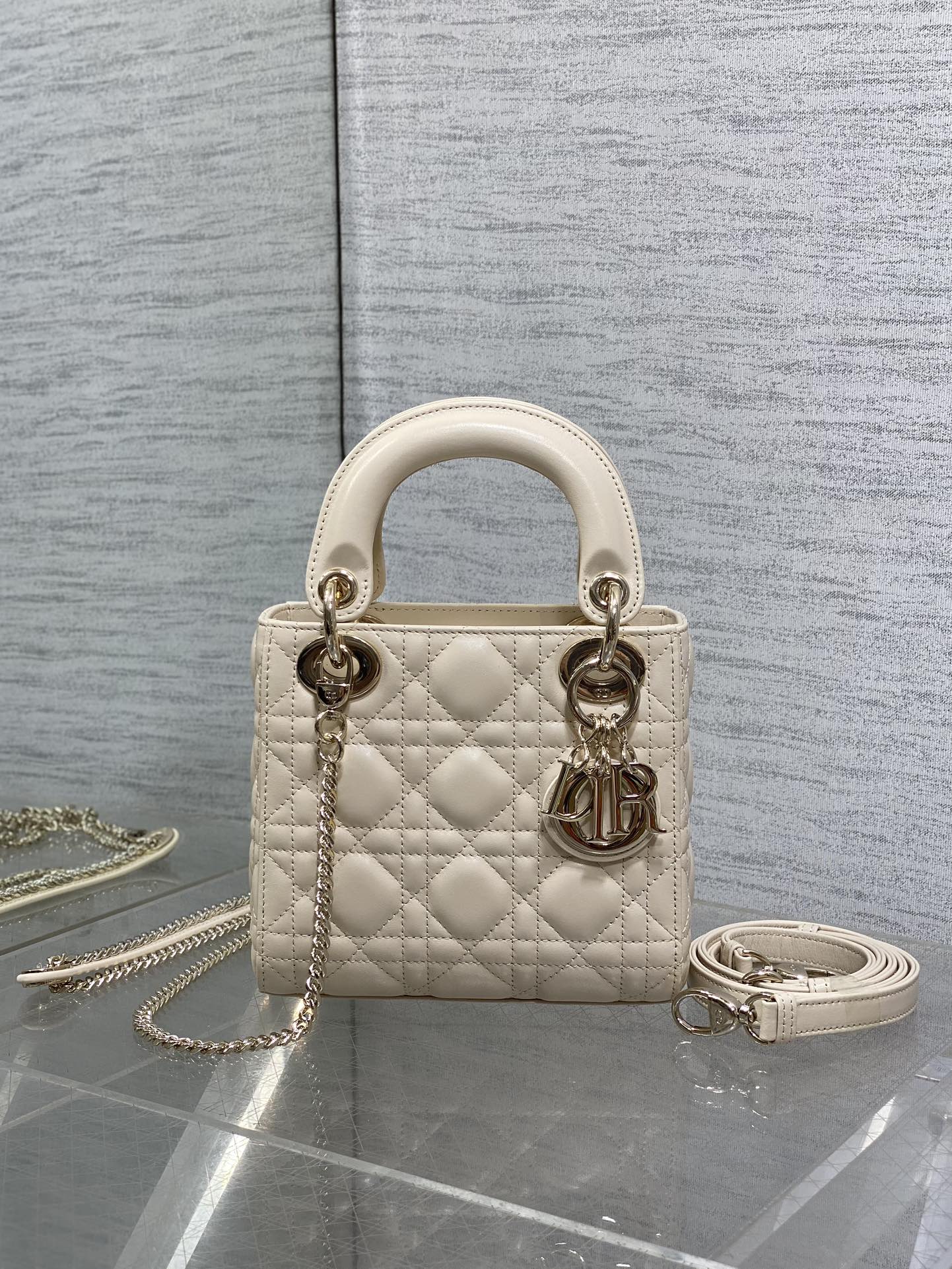 Light beige quilted Dior handbag, gold-tone hardware, top handles and chain strap