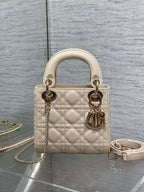 Light beige quilted Dior handbag with top handles, gold-tone hardware and chain strap