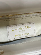 Christian Dior Paris "Made in Italy" leather label on a light beige bag