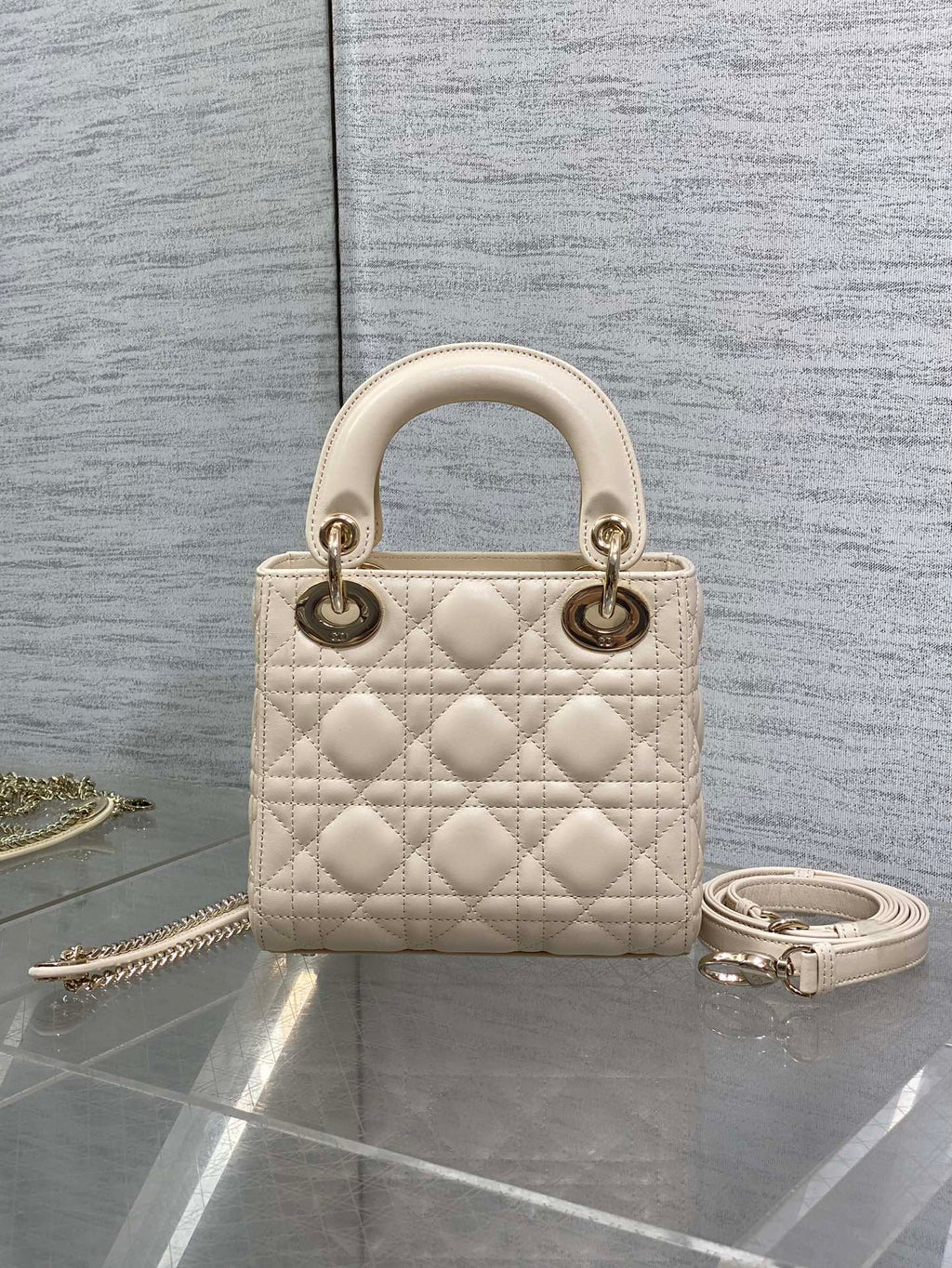 Light beige quilted Dior handbag, top handles, gold-tone hardware and chain shoulder strap