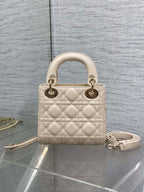 Light beige quilted Dior handbag, top handles, gold-tone hardware and chain shoulder strap