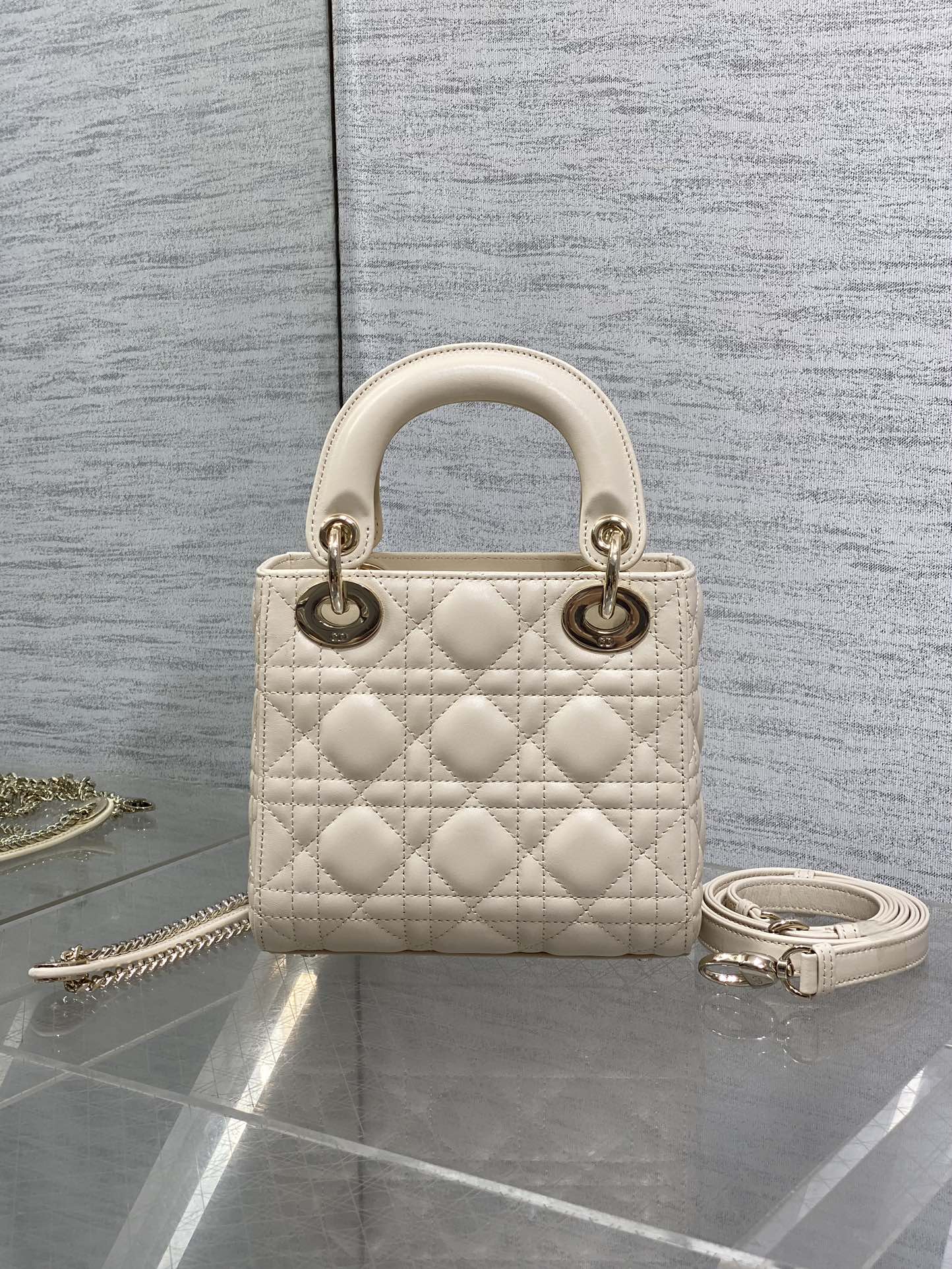 Light beige quilted Dior handbag, top handles, gold-tone hardware and chain shoulder strap