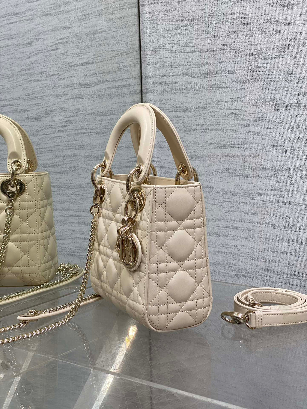 Light beige quilted Dior mini handbag with top handle and side chain strap