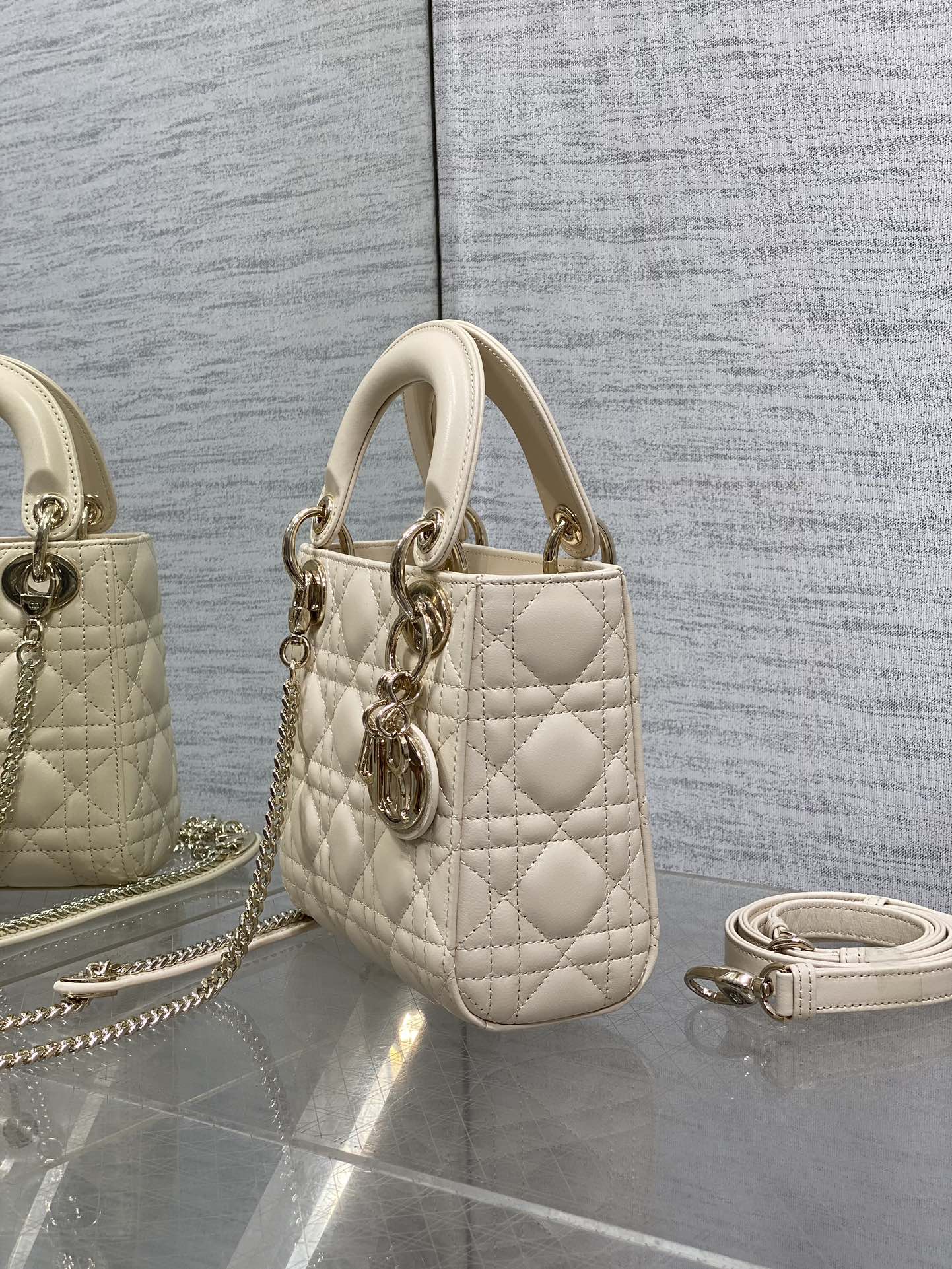 Light beige quilted Dior mini handbag with top handle and side chain strap