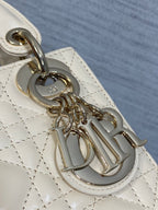 Dior handbag metal charm and clasp on quilted light beige leather