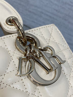 Silver-tone Dior charm hardware on cream quilted Dior bag