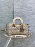 Cream quilted Dior bag with top handles and chain shoulder strap